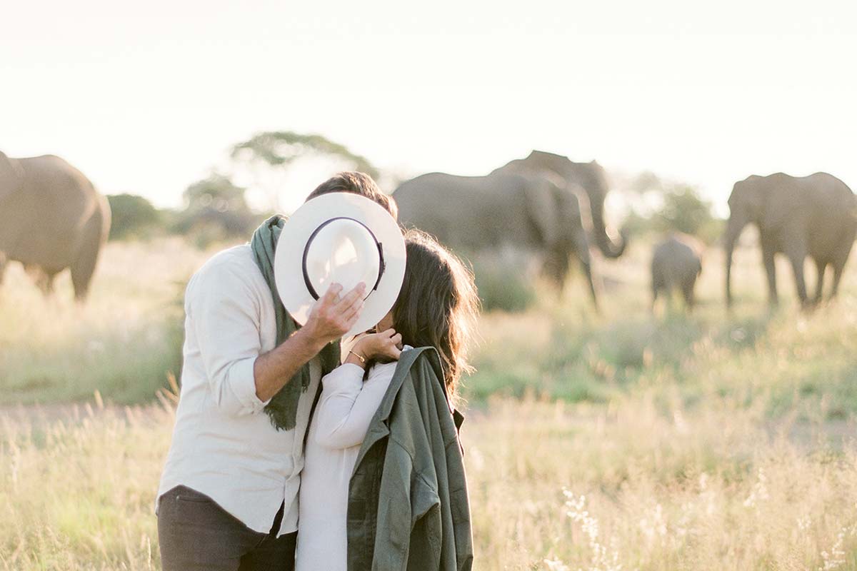 Couple sharing a romantic kiss during an African honeymoon safari