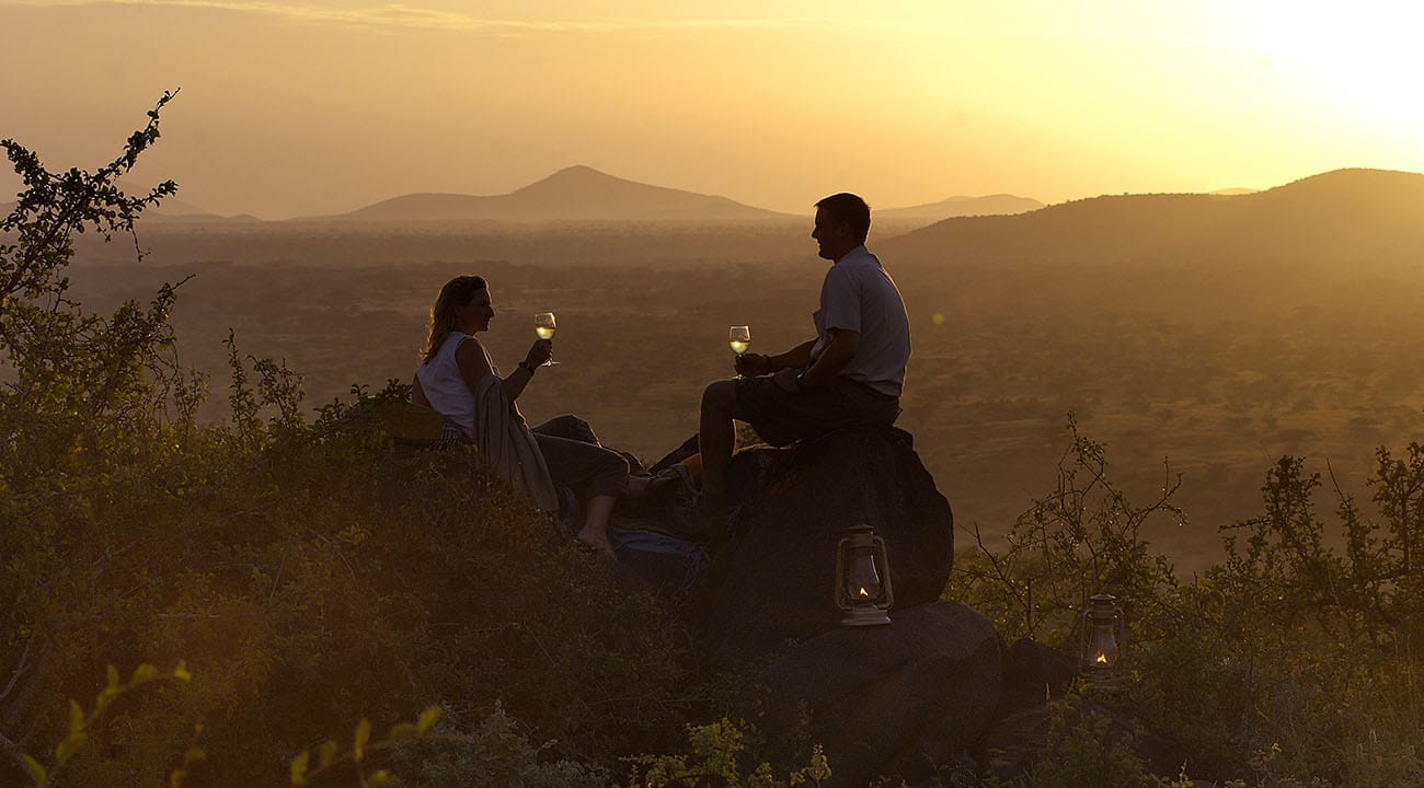 Couple enjoying evening breeze on African safari honeymoon